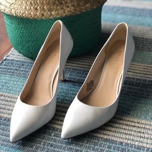 White pointed-toe pumps